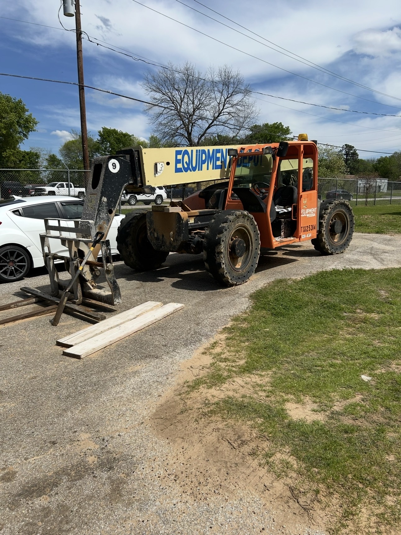 Orange telescopic boom forklift that may be oversized for current job site needs