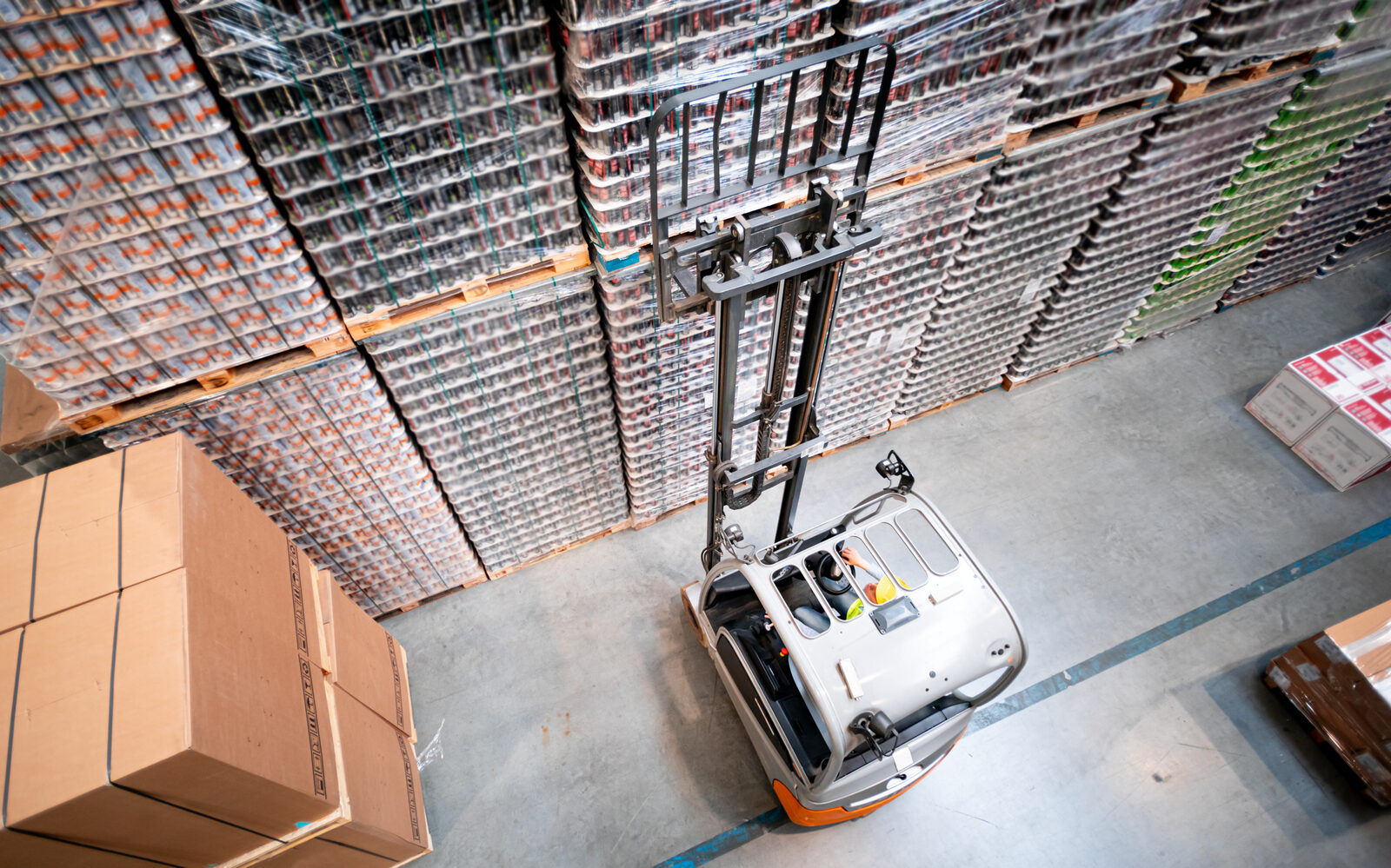 Warehouse lift equipment in use from an overhead view inside an active facility