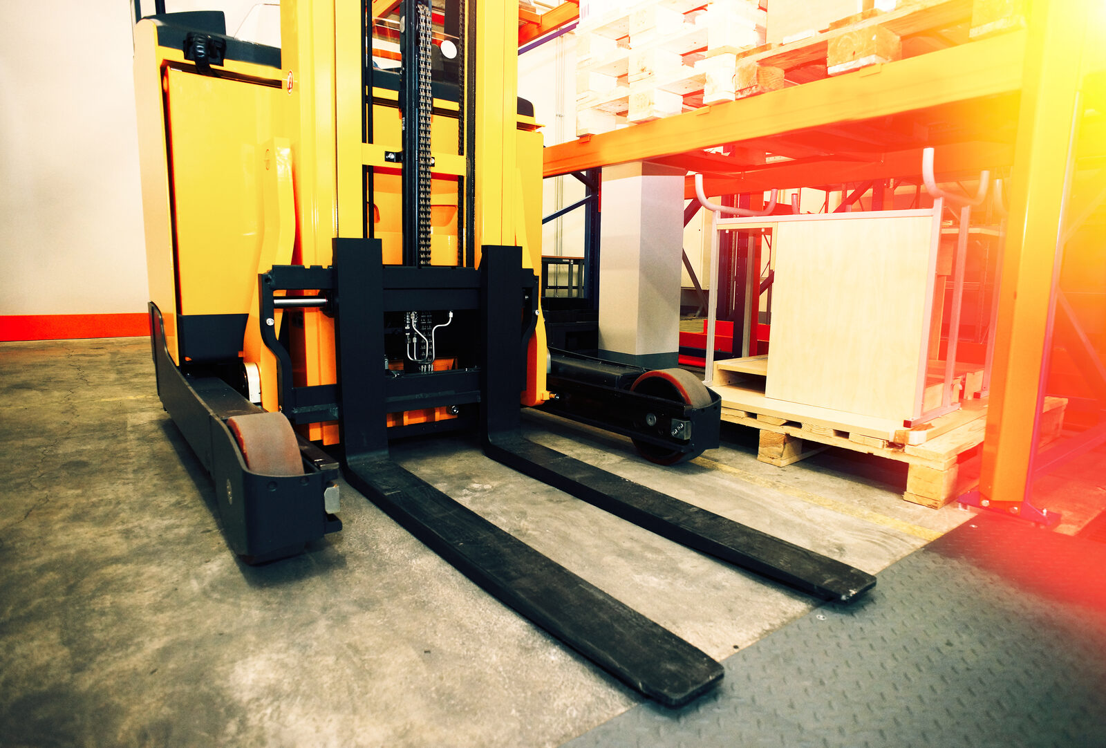 Warehouse shelves, racks, pallets, and lift equipment inside a distribution facility